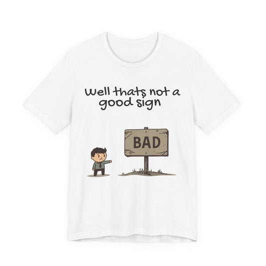 Bad Sign Cartoon Tee — Funny Dark Humor Graphic T-Shirt
