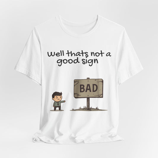Bad Sign Cartoon Tee — Funny Dark Humor Graphic T-Shirt